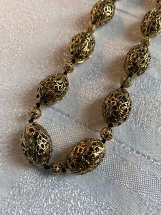 Vintage Monet gold tone filigree bead necklace  Quality piece, heavy and substantial  It measures 24 inches long inc the extender chain  In excellent condition, beads are knotted onto cord Oval beads approx 20 mm x 13 mm in size Antique Polished Gold Beads, Antique Large Gold Beads, Antique Gold Polished Beads, Adjustable Gold Necklace With Large Beads, Vintage Gold Polished Beads, Vintage Polished Gold Beads, Vintage Large Gold Beads, Vintage Gold Jewelry With Large Beads, Large Gold Beads For Costume Jewelry