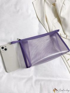 an iphone case sitting on top of a white bed