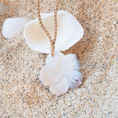 Embrace the essence of the ocean with our Moana Mother of Pearl Necklace, inspired by the Hawaiian word "moana," meaning "ocean." This exquisite necklace features a beautifully carved mother of pearl shell in the shape of a tropical flower, symbolizing the grace and beauty of the sea. The pendant is affixed to a twisted hemp rope, adding a touch of natural charm to the design. The adjustable rope necklace, secured with a bead, ensures a perfect fit for any occasion. Whether you're channeling your inner mermaid or simply adding a touch of island elegance to your outfit, the Moana Mother of Pearl Necklace is a timeless piece that celebrates the tranquility and allure of the ocean. Material: mother-of-pearl shell Pendant: ~ 2" Adjustable Length Hand carved, each unique Jewelry pouch included Ocean-inspired Mother Of Pearl Shell Necklace For Gift, Ocean-inspired Mother Of Pearl Shell Necklace As Gift, Ocean-inspired Mother Of Pearl Shell Necklace Gift, White Mother Of Pearl Pendant Shell Necklace, White Spiritual Shell Necklace, Spiritual White Shell Necklace Gift, White Spiritual Shell Necklace As A Gift, White Ocean-inspired Necklace In Mother Of Pearl, White Mother Of Pearl Ocean-inspired Necklace