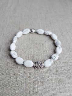 "READY TO SHIP. White Howlite Beaded Bracelet*Beaded Bracelets for Women*Bead Bracelet Women*Gemstone bracelet*White*Gift for her*Stretch bracelet for women. Beautiful natural White Howlite gemstone bracelet will make you look gorgeous. Howlite bracelet is the perfect addition to women's or girl's jewelry. Material: Natural Howlite gemstone, stretch cord, silver plated metal beads Color: White  Bracelet size: Approx. 17.15 cm / 6.75\" in (The size could be adjusted upon request) Beads size: Approx. 8x12 mm / 0.31\" x 0.47\" in Please note that color might slightly differ to photography.  For more natural gemstone bracelets, visit my shop: https://www.etsy.com/shop/LemonBracelet Thank you for shopping at LemonBracelet!" Cheap Everyday White Beaded Bracelets, Elegant Adjustable Howlite Jewelry, Howlite Bracelets With Round Beads As Gift, Natural Stone Bracelets For Gifts, Adjustable White Bracelet With Natural Stones, Adjustable White Crystal Bracelet With Gemstone Beads, Adjustable White Crystal Bracelet With Natural Stones, White Gemstone Beads Bracelet As Gift, White Beaded Crystal Bracelet For Healing