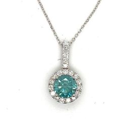 Stunning Diamond Halo Pendant and Chain Set in 18k White Gold The pictures don't fully capture the sparkle coming off of these diamonds. This could be the something blue for your wedding day Or a wonderful anniversary, birthday  or treat myself gift! The piece features a  beautiful Blue/ Green Diamond that is about a half a carat which is surrounded by 15 Bright White Diamonds for a total carat weight of 0.69 carats. The diamonds are prong set and the pendant is suspended on a 16 inch 18k solid Dazzling Blue Necklace With Brilliant Cut, Luxury Blue Diamond Necklace For Anniversary, Blue Luxury Diamond Necklace For Anniversary, Blue Diamond Necklace For Wedding, Blue Diamond Gemstone Necklace For Anniversary, Blue Diamond Pendant Necklace For Anniversary, Blue Diamond Cut Necklace For Anniversary, Blue Gemstone Diamond Necklace For Anniversary, Blue Diamond Wedding Necklace