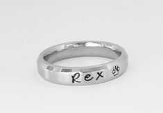 This gorgeous ring is 4 mm wide in solid stainless steel. It has a brushed finish with shiny rim and is a Comfort Fit ring, goes on like silk and will be the most comfortable ring you ever wear. I can fit up to 25 characters on this ring. Names, dates, quotes, scripture or roman numerals. This ring is dainty, and with it's flat surface the names really stand out. I sell this ring also on my page as a set of 2, this same style comes in 6 & 8 mm. Stainless steel never tarnishes, changes color, Adjustable Stackable Stainless Steel Rings, Adjustable Stackable Promise Rings With Custom Name, Adjustable Hand Stamped Initial Ring For Promise, Hand Stamped Stackable Rings For Promise, Adjustable Stainless Steel Engraved Promise Ring, Adjustable Hand Stamped Everyday Rings, Adjustable Hand Stamped Rings For Everyday, Adjustable Hand Stamped Engraved Ring, Everyday Hand Stamped Stackable Rings