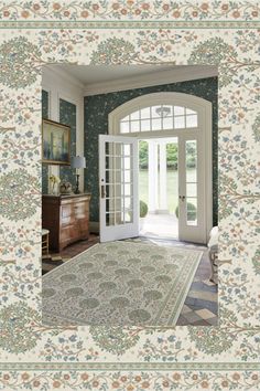 an ornately decorated room with french doors and rug on the floor in front of it