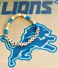 Detroit Lions bracelets 3 to a set dark blue and white with grey highlight. Detroit Lions on middle bracelet. You can order below how you want yours to look. Order today or tomorrow I will get them there before Sunday. Bracelets are strong and durable great colors with silver ring spacer in between. Casual Customized Blue Beaded Bracelets, Customized Adjustable Blue Bracelets, Custom Name Blue Bracelets With Round Beads, Casual Blue Name Bracelet For Everyday, Adjustable Blue Jewelry With Custom Name, Blue Jewelry With Custom Name, Casual White Beaded Bracelets For Personalized Gift, Custom Name Blue Beaded Bracelet For Friendship, Custom Name Blue Beaded Bracelets For Friendship