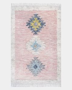 a pink and blue rug with fringes