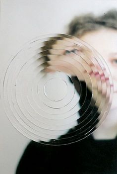 a blurry photo of a woman's face with her hands in the air