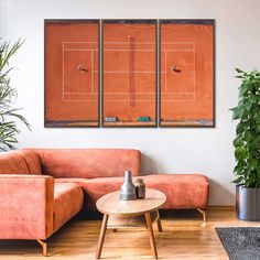 a living room with two couches and a tennis court on the wall above them