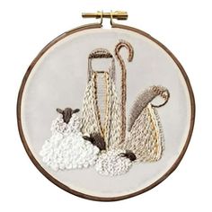 an embroidery project with sheep and umbrellas on it