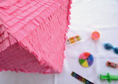 pink tissue paper and other craft supplies on a table