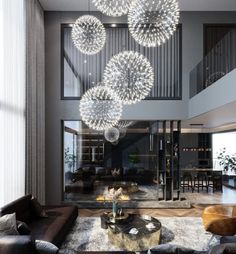 a living room filled with furniture and a chandelier hanging from the ceiling above it