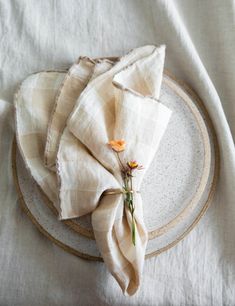 the napkins are folded on top of each other, with flowers in between them