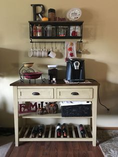 a coffee bar with shelves and cups on the top, below it is a wine glass rack