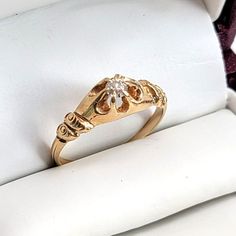 a gold ring sitting on top of a white pillow