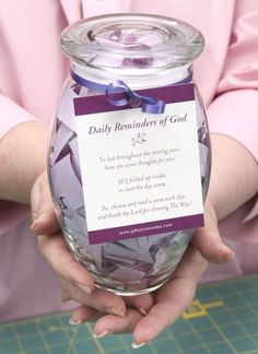 a person holding a jar filled with purple confetti