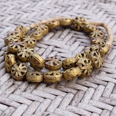 a close up of a bracelet on a woven surface