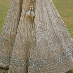 Featuring a nude gold raw silk lehenga set embroidered with traditional zardozi using gota patti, cutdana, sequins and dabka. Teamed with a matching embroidered blouse and a nude gold dupatta. An additional embroidered blush dupatta completes the bridal look. Composition: Lehenga and Blouse - Raw Silk, Dupatta- Net Care: Dry Clean Only and Vacuum Storage This product can be customised for colour, sleeves, length of blouse and neck design Delivery : 8-10 weeks as the product is hand crafted. For more information and sizes please contact fabiliciousfashion@gmail.com or visit our Copenhagen studio.About the Designer : Angad Singh's journey in the world of fashion started with at an early age as he grew up in a family business that was immersed in couture. Seeking to expand his knowledge, Anga Beige Anarkali Set With Gota Work For Wedding, Beige Gota Work Anarkali Set For Wedding, Anarkali Beige Sharara With Gota Work, Beige Anarkali Sharara With Gota Work, Beige Anarkali Set With Zari Work, Beige Anarkali Set With Zari Work For Reception, Beige Wedding Sets With Gota Work, Beige Gota Work Sets For Wedding, Designer Beige Sharara With Gota Work