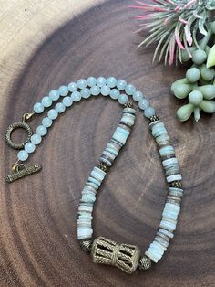 This boho inspired necklace will surely be your favorite summer accessory. It is made aqua jade, aqua/brown shells, nepal style brass beads, and brass pendant. The toggle clasp is also brass. This necklace measures 17 inches long. Tassel Necklace Boho, Grey Beads, Brass Beads, Inspired Necklace, Moonstone Necklace, Shell Necklace, Freshwater Pearl Necklaces, Brass Pendant, Shell Necklaces