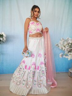 Go all out in this whimsical lehenga, studded with precious mirror, pearl, stone, embroidery work, which is sure to bring out the innate grace and grandeur in you! Color - White and Pink Fabric & Work Style - - Silk blouse: mirror, pearl, stone, embroidery work. - Soft net lehenga: mirror, pearl, stone, embroidery work. - Soft net dupatta: embroidery work. Details - - Assured quality - Wash care instruction: Dry clean only. - Slight variation in color is possible due to digital photography. Bridal Lehenga Indian, Bridal Jewelry Indian, Dupatta Embroidery, Lehenga Indian, Stone Embroidery, Indian Bridal Jewelry, Fabric Work, Indian Bridal Lehenga, Net Lehenga