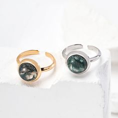 This delicate ring features stunning aquatic agate gemstones. The setting is meticulously crafted and the intricate details enhance the natural beauty of the stone, allowing its delicate hues to sparkle in the light. The adjustable strap ensures a comfortable fit, making it a versatile and elegant addition to any jewelry collection. Metal: 18K Recycled Gold Plated Vermeil on Recycled Sterling Silver,Recycled Sterling Silver Gemstone: Onyx 10mm Adjustable Ring Size: US 8 Water Grass, Edison Pearls, Onyx Gemstone, Tiger Eye Stone, Recycled Gold, Delicate Rings, Recycled Sterling Silver, Open Ring, Agate Gemstone