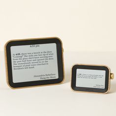 two kindle devices sitting next to each other on a white surface with one being read