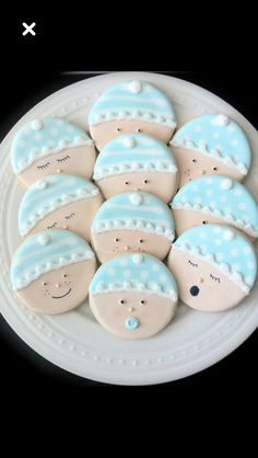 cookies decorated with blue and white designs on a plate