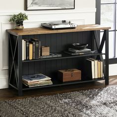 a book shelf with books and other items on it in front of a window next to a rug