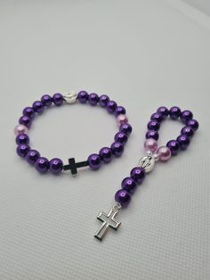 Matching set of handmade pocket rosary and bracelet  ☆ Glossy dark and light purple pearl beads ☆ Silver crosses and Blessed Mother charm Handmade in Scotland, Little Prayers, prayer beads are perfect for those little moments throughout your day. Through your hard times or times you want to give your thanks these beads will be the perfect tool for your prayers. Little Prayers are hand made one by one with love and hope that they will bring you comfort and happiness. Handmade Adjustable Purple Rosary, Purple Rosary With 8mm Round Beads, Purple Rosary With 8mm Beads, Purple Beaded Rosary As Gift, Handmade Spiritual Purple Rosary Bracelet, Adjustable Purple Rosary Bracelet, Adjustable Purple Spiritual Rosary Bracelet, Adjustable Purple Rosary Bracelet With 8mm Beads, Pocket Rosary