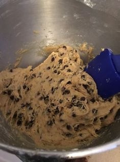 a metal bowl filled with batter and chocolate chips