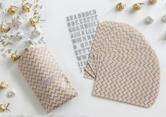 two envelopes and some confetti on a white table with gold foil decorations