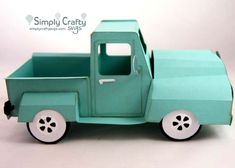 a green toy truck sitting on top of a white table next to a sign that says simply crafty