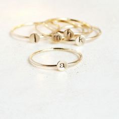 A teensy tinsy silver personalized initial ring so cute you'll fall in love!  This listing is for 14/20 gold filled. Customize this delicate stacking ring with the initial or symbol you desire for a very wearable, everyday ring.  The slim 1mm band and 4mm disk (slightly smaller than our original 5mm round - see comparison photo) makes this literally THE most perfect ring for stacking! Just the right find for a lucky momma or grandmother of many. Also sweet for creating a short word by stacking m Simple Stackable Initial Ring For Everyday, Simple Personalized 14k Gold Midi Rings, Dainty Tiny Initial Ring For Anniversary, Personalized Dainty Initial Ring In Rose Gold, Simple 14k Gold Initial Ring, Personalized Dainty Rose Gold Initial Ring, Everyday Adjustable Stackable Rings With Initials, Minimalist Midi Rings With Initials, Minimalist Personalized Yellow Gold Midi Rings