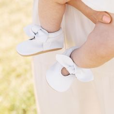 Step into pure elegance with our updated bright white mocc collection! Knotted Bow Mocc Bright White Leather Weathered Brown Leather Sole Choose between soft sole for your infant OR rubber hard sole for your little on the go Soft soles come in sizes Newborn - 7 Hard soles come in sizes 3 - 7 Baptism Booties With Soft Sole And Round Toe, Spring Booties With Soft Sole And Round Toe, White Non-slip Booties With Round Toe, Spring Playtime Booties With Rubber Sole, Cute Spring Booties With Soft Sole, Spring Closed Toe Playtime Booties, White Booties With Rubber Sole For Playtime, Spring Closed Toe Booties For Playtime, White Booties For Baptism