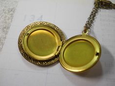 "This is a 1\" solid brass locket with a beautiful ornate brass charm on the face. Locket opens to hold two 3/4\" photos. You choose the chain length in the drop down menu above. The locket and the charm on the top are both vintage 1960's stock and I have created a one of a kind locket using both components. The perfect necklace for layering! A nice dainty size. The chain is also solid brass and you may choose your preferred length in the drop down menu above. I offer quick shipping and all pack Beetle Wings, Handwritten Gifts, Brass Charms, Locket Necklace, Organza Bags, Chain Lengths, Locket, Solid Brass, Womens Necklaces