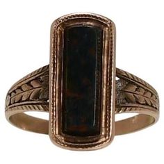 Elevate your jewelry collection with the enchanting beauty of this Victorian 10K Warm Gold Bloodstone Shield Ring adorned with intricate milgrain detail. The bloodstone, with its deep green and red speckled hues, takes center stage, exuding an air of mystery and elegance. The meticulously crafted milgrain accents add a touch of vintage charm, making this ring a stunning and timeless piece that beautifully captures the essence of the Victorian era. Ring Size: 6.25 Metal Type: 10K Gold (Tested) We Shield Ring, Charm Making, Traverse City, Green And Red, Center Stage, Jewelry Rings Engagement, Deep Green, Victorian Era, 10k Gold