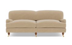 a beige couch sitting on top of a white floor