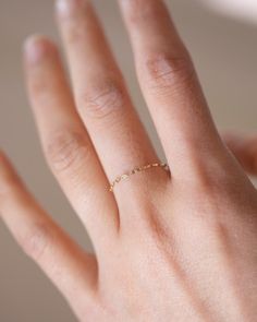 This 14k Solid Gold dainty dapped chain ring is both modern and timeless. It features a super dainty link chain design that adds a delicate touch to any outfit.Perfect as a stacking ring or by itself.*If you are in between sizes or need a specific size leave us a note while check out. 14k Gold Link Chain Ring, Adjustable Chain Midi Rings For Promise, Delicate Rings With Adjustable Chain, Minimalist 14k Gold Link Chain Ring, Dainty Stackable Chain Ring For Anniversary, Delicate Rings With Delicate Chain As Gift, Minimalist Stackable Chain Ring For Weddings, Dainty Figaro Chain Jewelry For Wedding, Delicate Chain Rings As Gift