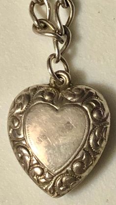 "This is a fabulous mini-collection of sterling silver hearts on a silver bracelet, ready to wear and add on if desired. You are buying FOUR puffy heart charm pendants for ONE price. They are ALL sterling silver and stamped. All of these hearts appear to be older, non-repros, dating to the early 1900s. They are on a 7\" silver (unmarked) charm bracelet and weigh a total of 8.7 grams. In very good vintage used condition, these are all sold as found, unpolished, lovely patina, all original and fre Heart-shaped Hallmarked Bracelets As A Gift, Sterling Silver Bracelet For Valentine's Anniversary, Silver Double Heart Bracelet For Anniversary, Silver Heart Bracelet For Mother's Day, Valentine's Day Heart Charm Jewelry Collectible, Anniversary Heart Pendant Charm Bracelet, Valentine's Day Collectible Jewelry With Heart Charm, Valentine's Day Collectible Heart Charm Jewelry, Vintage Nickel-free Heart Bracelet As Gift