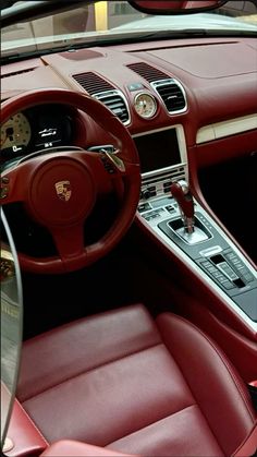 the interior of a car with red leather