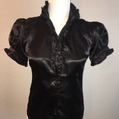 Black Satin Blouse Size Small Or 4 True To Size Perfect New With Tags And Spare Button Button Down Front Tie Short Sleeved Model Is Sz 6 Fitted V-neck Blouse With Buttons, Fitted Blouse With Button Closure, Short Sleeve Party Tops With Buttons, Short Sleeve Party Shirt With Buttons, Fitted Blouse With Covered Buttons For Office, Fitted Tops With Covered Buttons For Office, Party Shirt With Short Sleeves And Buttons, Fitted Button-up Shirt With Padded Blouse, Formal Fitted Blouse With Back Button Closure