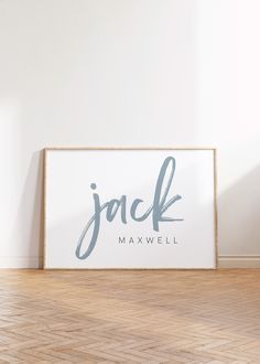 a sign that reads jack maxwell on it in front of a white wall and wooden floor