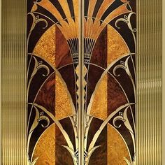 an art deco glass door with gold and brown designs