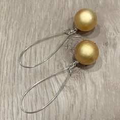 These handcrafted earrings are so pretty and unique!  18mm round glowing golden beads dangle from silver plated kidney hoops.  These earrings measure almost 2.75 inches in length.  Lightweight and FABULOUS Item is carefully packaged and shipped via USPS in a sturdy protective mailer. Check out more fabulous jewelry and enter my shop here: https://www.etsy.com/shop/jewelbytessyla View the positive feedback I've received from customers and check out some beautiful art prints for nursery and home a Handmade Gold Wrap Earrings For Party, Yellow Ear Wire Party Earrings, Teardrop Earrings Gift, Elegant Nickel-free Beaded Earrings For Festive Occasions, Elegant Festive Beaded Earrings Nickel Free, Elegant Festive Nickel-free Beaded Earrings, Gold Teardrop Earrings With Round Beads For Gifts, Handmade Sterling Silver Clip-on Earrings For Party, Gold Beaded Sterling Silver Earrings For Gift