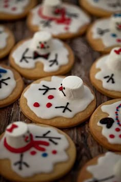 decorated cookies with frosting and icing are arranged on a table