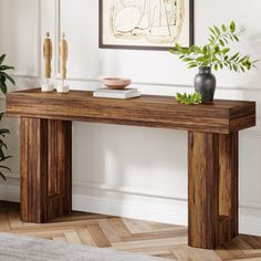 a wooden table with two vases on it and a plant in front of it