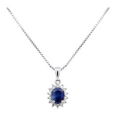 Item Details: - Type: Drop Pendant Necklace  - Metal: 18K White Gold  - Weight: 1.05 Grams (pendant only) - Setting: Prong, Halo ______________________________  Center Stone Details: - Type: Natural Sapphire  - Carat: 1.20  - Cut: Oval  - Color: Blue  - Measurements: 6.5 X 5 MM  ______________________________  Side Stone Details:  - Type: Natural Diamond  - Cut: Round  - Color: G-H - Clarity: SI1-SI2 - Quantity: 14  ______________________________  Dazzling modern drop pendant necklace, featuring a 1.20 carat natural oval cut Sapphire radiating a deep royal blue. This center stone is matched with 14 piece round-cut diamond halo in a star motif pendant made of 18K white gold. Set with an open back to allow for the center stone's natural color to be on full display.   The default order comes Oval Sapphire Necklace For Anniversary, Formal Blue Oval Diamond Necklace, Blue Oval Diamond Necklace In Fine Jewelry Style, Oval Sapphire Necklace With Brilliant Cut, Blue Oval Diamond Necklaces, Blue Oval Diamond Necklace Fine Jewelry, Oval Blue Diamond Necklaces, Oval Sapphire Necklace With Halo Setting, Sapphire Oval Necklace With Diamond Cut