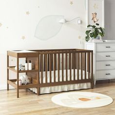 a baby's room with a crib and dresser