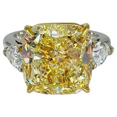 a fancy yellow diamond ring with three stones