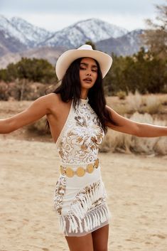 Go all out this festival season in the Like Gold Dust White Sequin Fringe Dress. The intricate pearl and sequin details on this piece will stand out amongst the crowd without a doubt. A great fit for any body type! PRODUCT DESCRIPTION AND MATERIALS: - sleeveless white sequin and pearl fringe dress - belt not included - button closure at the neck - zipper closure at the back - pearl details at neck and waist band - fishnet trim at hem and floral sequin embroidery - self, contrast, tassels: 100% p Cowgirl Editorial, Cowgirl Shoot, Sequin Fringe Dress, Cowgirl Dress, Pearl Fringe, Cowgirl Dresses, White Fringe, Sequin Crop Top, Pearl Details