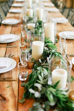 a long table is set with candles and place settings for dinner guests to enjoy the meal