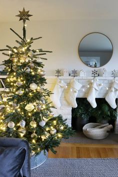 a decorated christmas tree in front of a fireplace